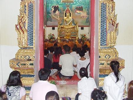 Devout Buddhists make merit at their local temple on Makha Bucha Day last year.